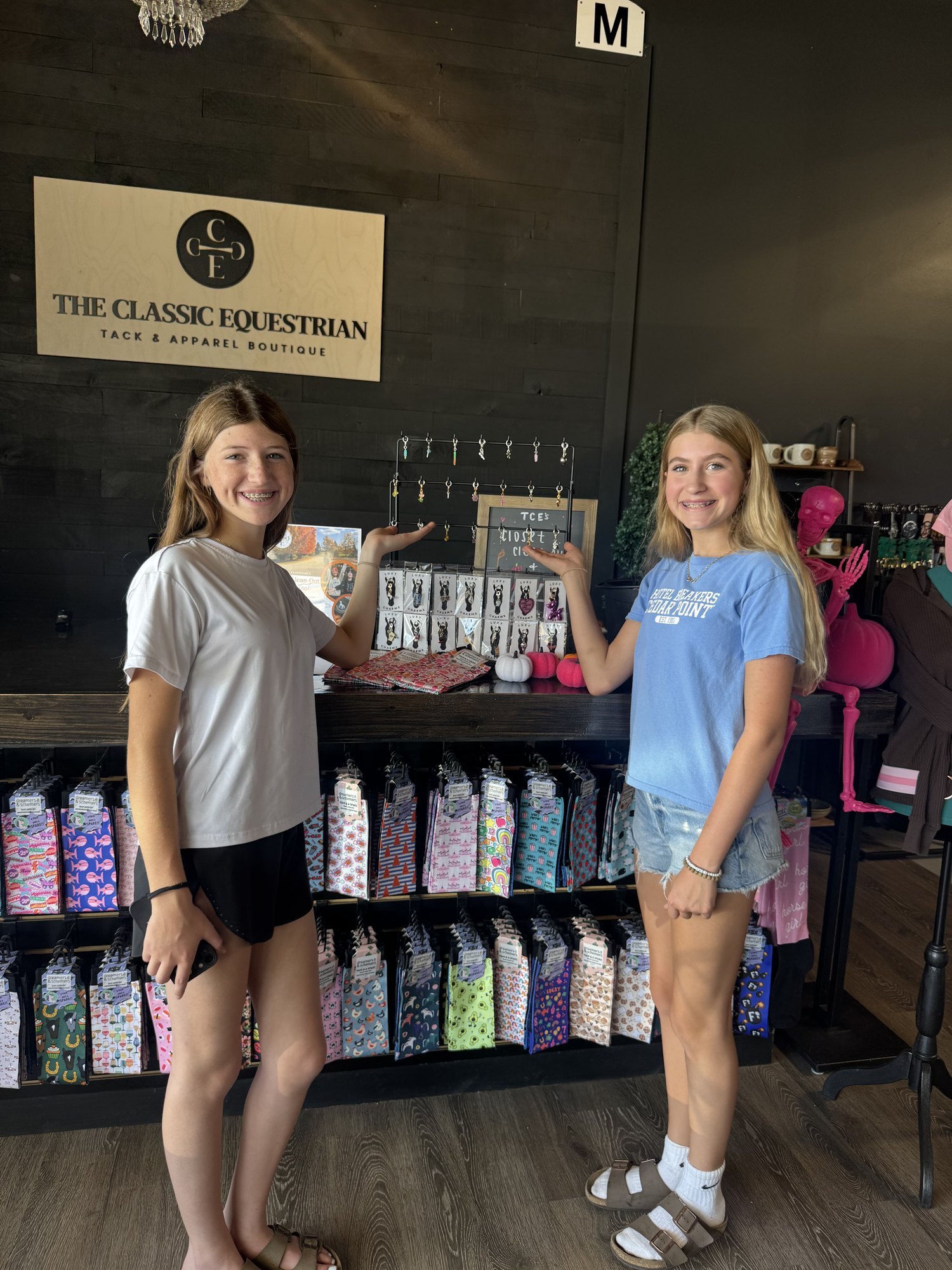 Sadie and Olivia at The Classic Equestrian retail boutique with their charm display